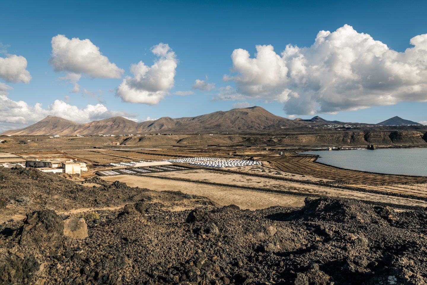 Lanzarote. Part II

Across our two journeys to Lanzarote, few locations captivated my lens quite like the Salinas de Janubio. Situated along the island’s southwestern edge in the municipality of Yaiza, these salt flats were established around 1895 within a dramatic natural basin formed by the volcanic eruptions of 1730. Lava flows sculpted a sweeping lagoon roughly a kilometer in circumference, creating a vast natural amphitheater where sea water—channeled historically by windmills and now powered by modern pumps—slowly evaporates under the island sun....

https://www.mercedescatalan.com/2026/08/25/lanzarote-part-ii/
